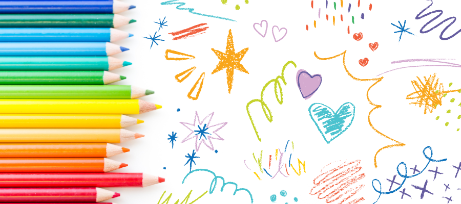 Colored pencils lying next to colorful doodles and scribbles