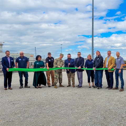 Photograph of people cutting a ribbon in celebration of a pump station completion in Kansas City, Kansas