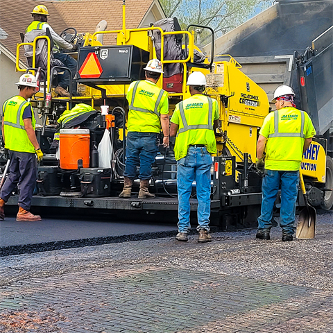 Photograph of crews applying fresh pavement to a local street in Kansas City, Kansas