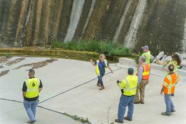 A photograph of people walking down a very large concrete ramp