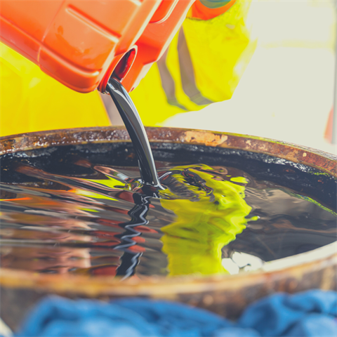 Photograph of used oil being poured into a container