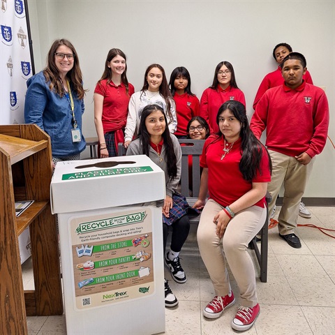 Resurrection Catholic School students sitting on a bench made from recycled plastic in Kansas City, Kansas