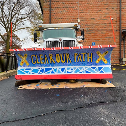 Photograph of a snowplow painted by students from Kansas State School for the Blind in 2022 that says 