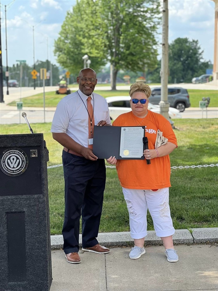 Mayor with proclamation for wyco moms demand action.jpg