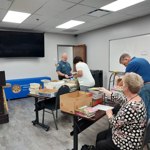 kiwanis at sheriff's office prepping books 